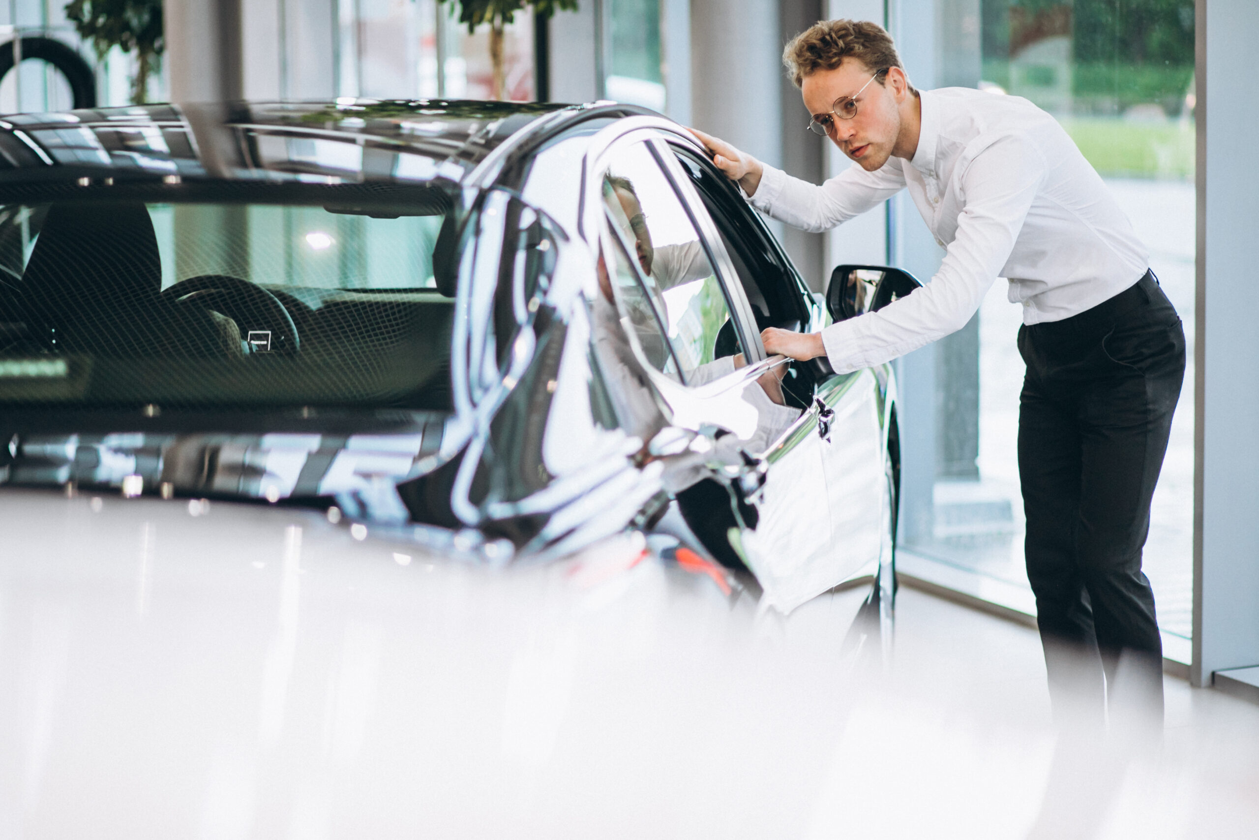 Tesla collision repair estimate and insurance paperwork on a shop counter