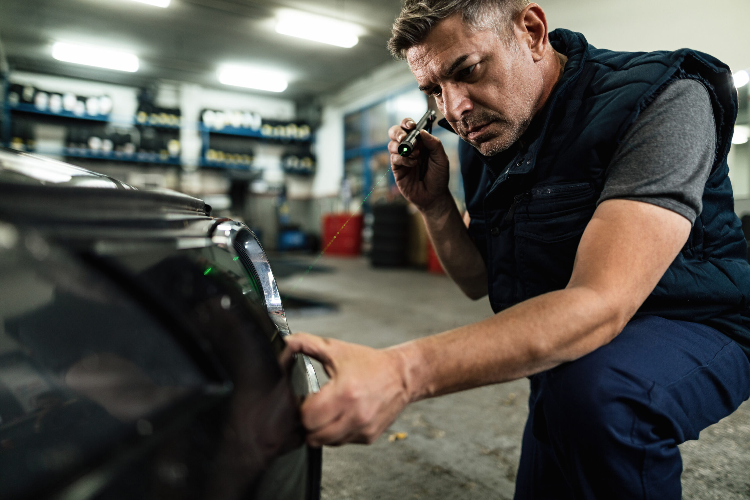 Technician calibrating Tesla sensors after a collision repair