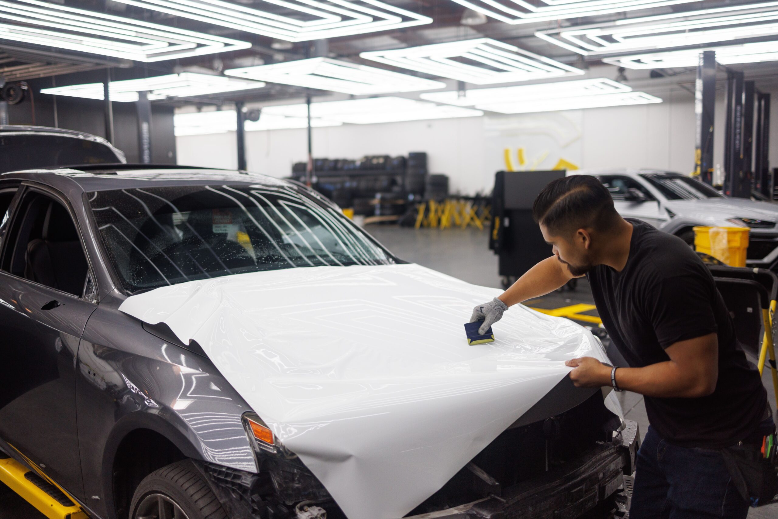 Beverly Hills collision repair bay with a luxury vehicle in progress