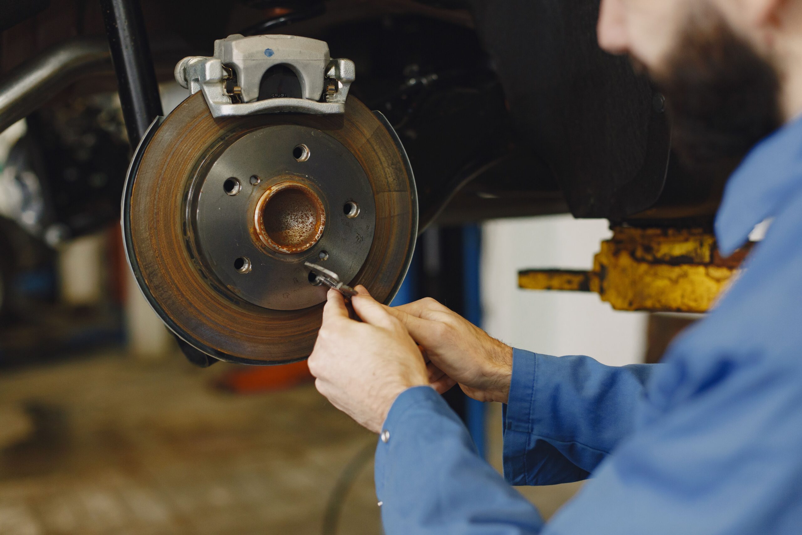 Technician inspecting Tesla brake components