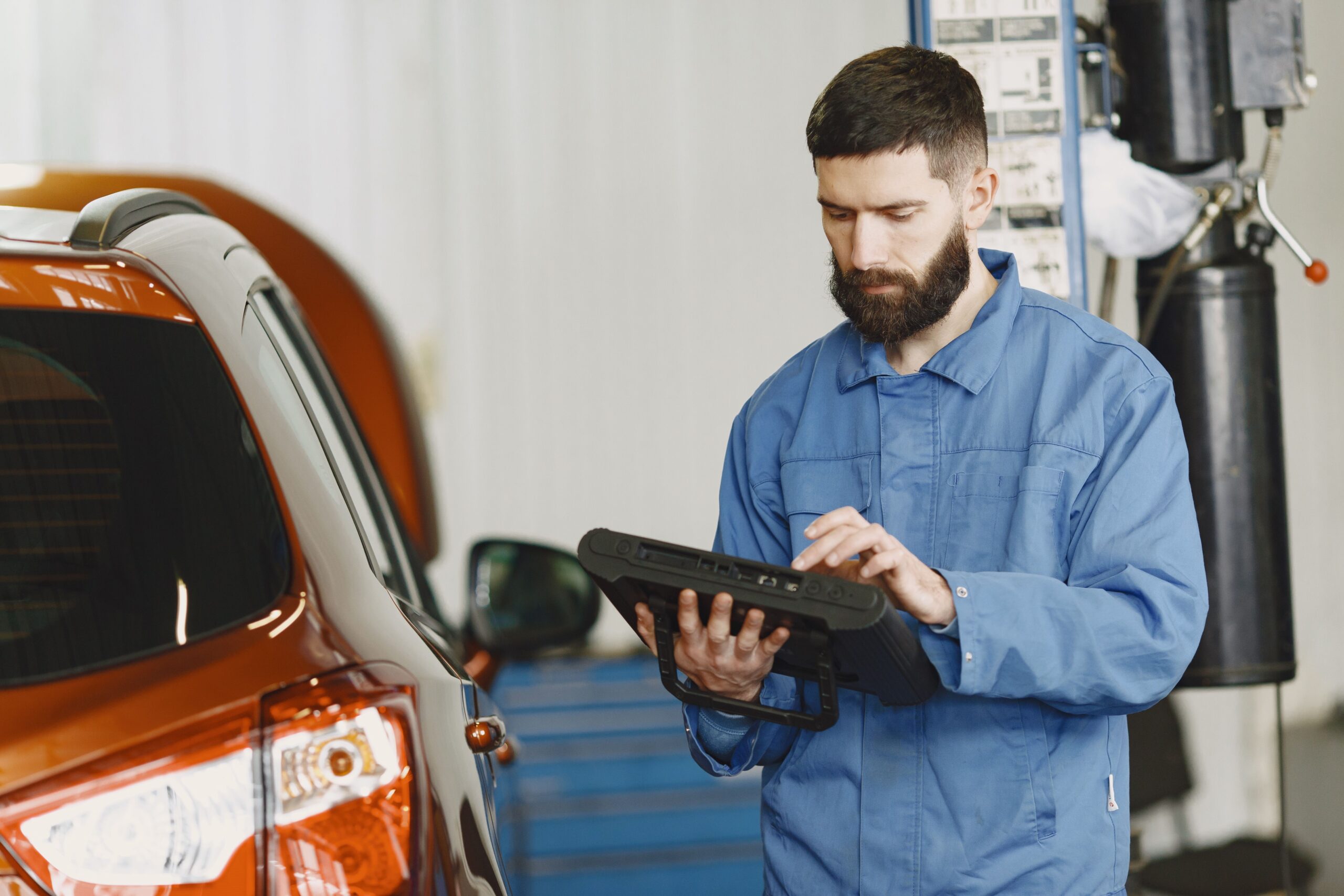 Tesla-certified technician reviewing a collision repair estimate